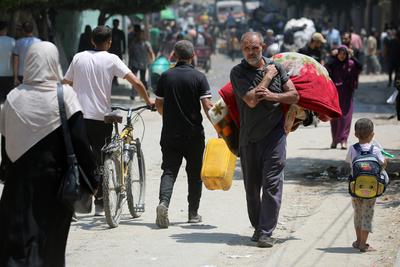 Palestinians, carrying their personal belongings, try to fled to safer areas to escape from Israeli attacks on Jabalia-stock-photo