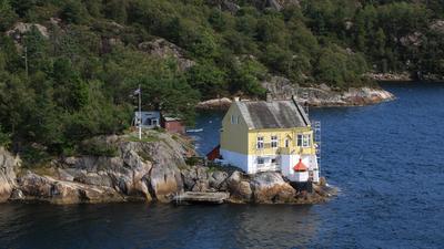 House with a small lighthouse near Bergen, Norway. House with a small lighthouse near Bergen, Norway. Copyright: xZoonar-stock-foto