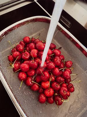 Nature healthy nutrition summer fruits Fresh cherries in the kitchen sink under running water-stock-photo