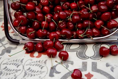 Nature healthy nutrition summer fruits Fresh cherries in colander on retro tile backgroun-stock-photo