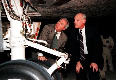 NASA Administrator Daniel Goldin (left) and Director of Space Shuttle Operations Bill Readdy look at the underside of th-stock-photo