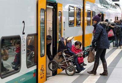 12 03 2016 Berlin Deutschland Eltern heben einen Kinderwagen in einen Zug der ODEG 00S160312D80-stock-foto
