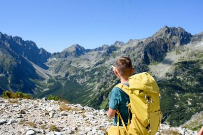 Boy on hike in autumn mountains. Kids spending summer break in nature. Rear view. Boy on hike in autumn mountains. Kids-stock-photo