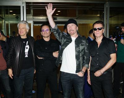 MUMBAI, INDIA - DECEMBER 12: Lead vocalist Bono, lead guitarist and keyboard player The Edge, bass guitarist Adam Clayt-stock-photo