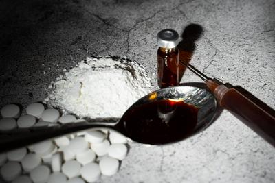 Augsburg, Bavaria, Germany - February 13, 2024: Symbolic image of drugs and illegal substances. A spoon with a brown liq-stock-foto