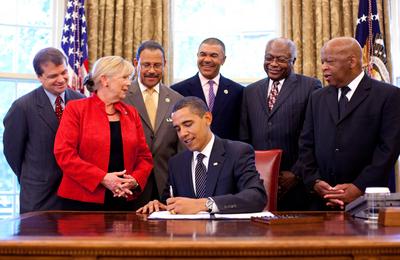 President Barack Obama signs the Civil Rights History Project Act of 2009 bill into law in the Oval Office of the White-stock-photo