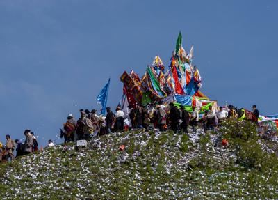 Wei Sang Fest in Tibet ABA, CHINA - JUNE 26: Locals dressed in traditional Tibetan attires throw prayer papers as they g-stock-photo