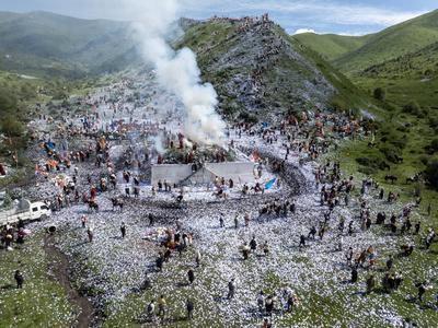 Wei Sang Fest in Tibet ABA, CHINA - JUNE 26: Locals dressed in traditional Tibetan attires throw prayer papers as they g-stock-photo