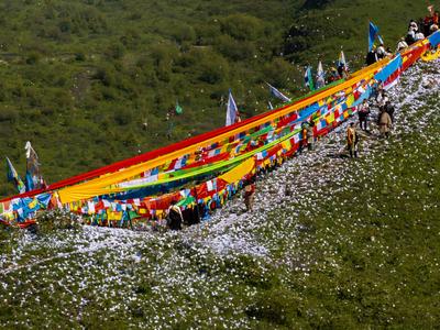 Wei Sang Fest in Tibet ABA, CHINA - JUNE 26: Locals dressed in traditional Tibetan attires throw prayer papers as they g-stock-photo