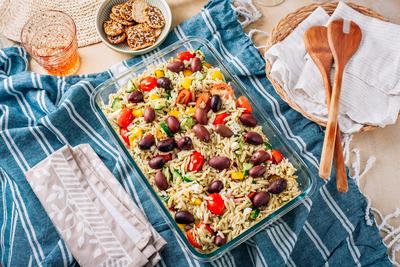 Picnic time - homemade orzo pasta salad with feta Picnic time - homemade orzo pasta salad with feta, olives, tomatoes Co-stock-photo