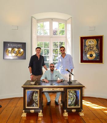 Kollegah Felix Blume Family & Friends Sommerfest - Felix Blume an seinem vergoldeten Schreibtisch mit Thomas Brdaric (li-stock-foto