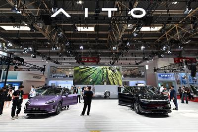 BEIJING, CHINA - JULY 17: People visit the booth of AITO at the Smart Vehicle Chain area during the 3rd China Internatio-stock-photo
