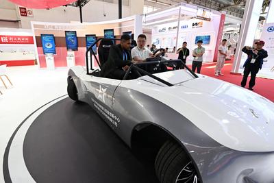 BEIJING, CHINA - JULY 17: People visit the Smart Vehicle Chain area during the 3rd China International Supply Chain Expo-stock-photo
