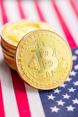Bitcoin gold coin. Cryptocurrency on american flag Bitcoin gold coin. Cryptocurrency on the american flag Copyright: xZo-stock-foto