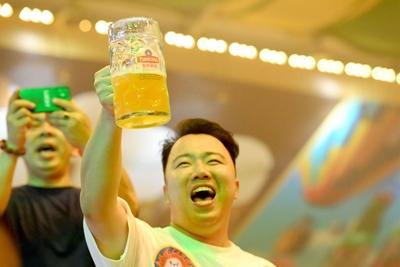QINGDAO, CHINA - JULY 18: Visitors have fun during the 35th Qingdao International Beer Festival at the Xihai an (West Co-stock-photo