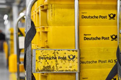 Germering, Bavaria, Germany - 18 March 2025: Roll containers full of mailboxes with the Deutsche Post AG logo at the Ger-stock-foto