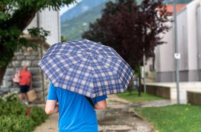 Nago-Torbole, Trentino, Italy - July 21, 2025: Storm on Lake Garda with extreme rainfall and thunderstorms. Tourist walk-stock-foto