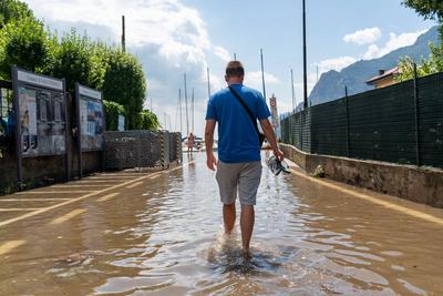 Nago-Torbole, Trentino, Italy - July 21, 2025: Storm on Lake Garda with extreme rainfall and thunderstorms. Tourist walk-stock-foto