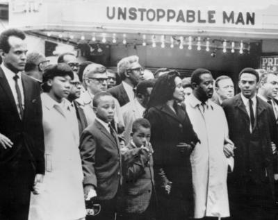 A cinema bill provides an ironic background during the march for slain civil rights leader Dr Martin-stock-foto