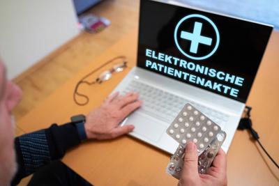 Germany - April 17, 2025: PHOTO MONTAGE, A senior citizen uses a laptop to access his electronic patient record (EPA). E-stock-foto