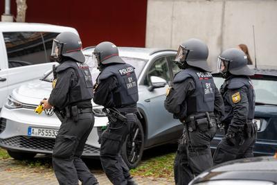 Bavaria, Germany - October 18, 2024: Masked police officer of a special unit of the riot police with Taser on the way to-stock-foto