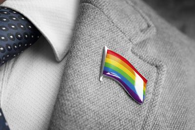 Metal badge with the flag of lgbt on a suit lapel Metal badge with the flag of lgbt on a suit lapel. Copyright: xZoonar.-stock-foto