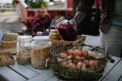 Close up of man buying organic juice outdoors at local farmers market. A close up of man buying organic juice outdoors a-stock-photo