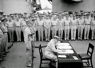 JAPANESE SURRENDER General Douglas MacArthur signs as Supreme Allied Commander during formal surrender ceremonies on the-stock-photo