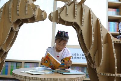 CHONGQING, CHINA - JULY 25: A girl reads a book a book during the 33rd National Book Expo on July 25, 2025 in Chongqing,-stock-foto