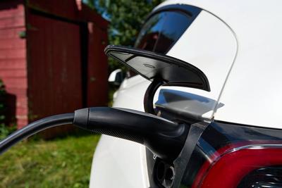 Bavaria, Germany - June 24, 2025: Detailed view of a Tesla Model Y during the charging process. A charging cable is conn-stock-foto