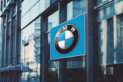 Illuminated banner with bmw car manufacturer s logo on a glass office building. Illuminated banner with bmw car manufact-stock-photo