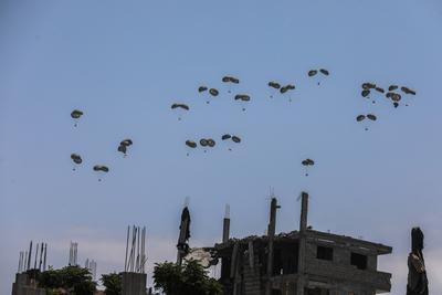 An airplane drops humanitarian aid over Gaza as seen from northern Gaza Strip-stock-foto