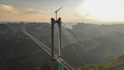 QIANXINAN, CHINA - AUGUST 02: Aerial view of a construction site of the Huajiang Grand Canyon Bridge on August 2, 2025 i-stock-foto