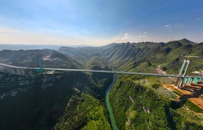 QIANXINAN, CHINA - AUGUST 02: Aerial view of a construction site of the Huajiang Grand Canyon Bridge on August 2, 2025 i-stock-foto
