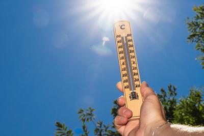 Bavaria, Germany - 30 June 2025: A thermometer in front of bright sunlight shows temperatures close to 40 degrees - this-stock-foto