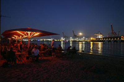 cntv Uebersicht Hafen Himmel Mond Wolken Strand Die warmen Temperaturen und der fast Vollmond sorgten am Freitag abend 08.August 2025 am Hamburger Elbstrand im Bereich Oevelgoenne fuer ein mediterranes Feeling was zahlreiche Menschen genossen haben. Die F?sse im Sand des Elbstrandes, der Blick auf den Mond am Strand und dazu ein Glas Wein oder Sekt die perfekte Urlaubsstimmung Hamburg Deutschland *** cntv Uebersicht Hafen Himmel Mond Wolken Strand The warm temperatures and the almost full moon provided a Mediterranean feeling on Friday evening August 08, 2025 on Hamburgs Elbe beach in the Oevelgoenne area, which many people enjoyed The feet in the sand of the Elbe beach, the view of the moon on the beach and a glass of wine or sparkling-stock-foto
