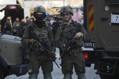 Israeli security forces stand guard as Israeli settlers tour in the Palestinian side of the old city and market of Hebron-stock-foto