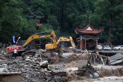 YUZHONG, CHINA - AUGUST 10: Excavators restore a damaged river course and structures after continuous heavy rainfall tri-stock-foto