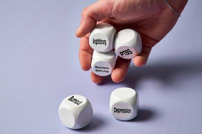 Bavaria, Germany - December 20, 2024: A hand holds cubes with terms such as anxiety disorder, PTSD and bipolar disorder,-stock-foto