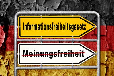 Bavaria, Germany - March 30, 2025: PHOTOMONTAGE, Two directional signs in front of a German flag: Freedom of Information-stock-foto