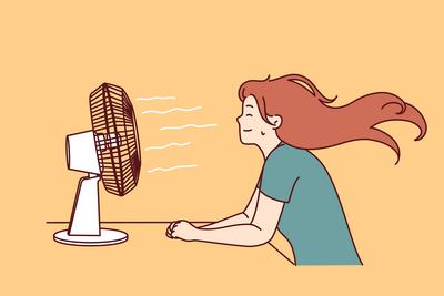 Woman sitting in front fan enjoying cold wind after walking in hot summer weather or doing housework-stock-foto