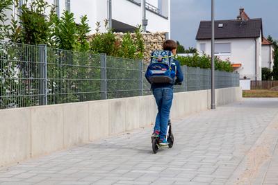 Symbolbild: Schulkind mit Tretroller auf dem Schulweg (model released) *** Symbolic image of a schoolchild with a scoot-stock-foto