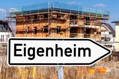 Bavaria, Germany August 13, 2025: PHOTO MONTAGE, street sign Eigenheim (own home) in front of a new building stands for-stock-foto