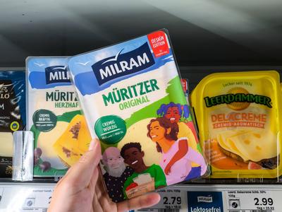 Bavaria, Germany - August 19, 2025: Milram M?ritzer cheese in the refrigerated section of a food supermarket. A customer-stock-foto