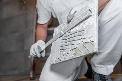 Bavaria, Germany - August 25, 2025: The tile is measured precisely with a folding rule to ensure a perfect fit. A precis-stock-foto