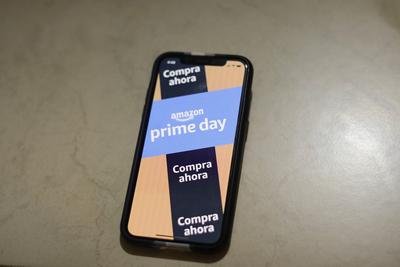 People Take Advantage of Amazon Prime Day Offers Amazon advertising is seen on a cell phone that offering promotions ava-stock-foto