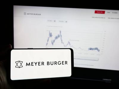 Person holding mobile phone with logo of Swiss photovoltaics company Meyer Burger Technology AG. Stuttgart, Germany - 05-stock-foto