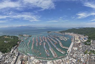 YANGJIANG, CHINA - SEPTEMBER 23: Boats and vessels are moored at Zhapo Fishing Port to take shelter from heavy winds as-stock-foto