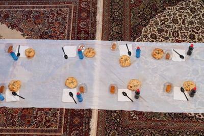 Top view of people serving food at a Mosque a communal meal during Ramadan before breaking the fast on Iftar dinner. Warm festive atmosphere celebrating Ramadan Karim and Eid, the Islamic holy month of Islam.-stock-foto