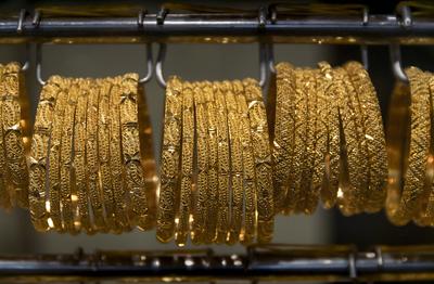 Dubai: Gold im Souk. Armreife aus Gold hängen in der Auslage eines Geschäfts im Goldsouk von Dubai. Der Souk im Stadttei-stock-foto